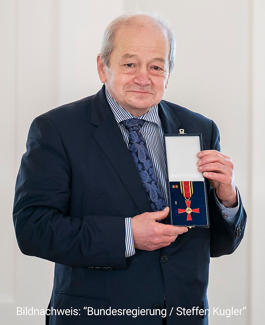 Dr Cem Özbek präsentiert sein Bundesverdienstkreuz